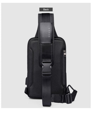 Black crossbody bag back view with adjustable strap and padded mesh back panel.