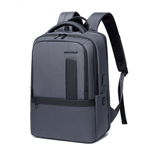 Grey waterproof travel backpack with top handle, front pocket, and side straps