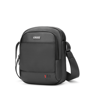 Dark grey compact waterproof messenger bag with logo patch and front zip pocket