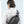 Black sling bag back view with key pocket, earphone hook, and USB charging