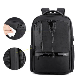 Waterproof black travel backpack with sealed-looking front panels and textured fabric.
