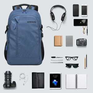 Blue travel backpack with front zipper pocket and cushioned back; accessories shown