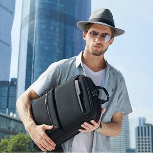Black waterproof business backpack with front vertical zipper and side carry handle