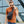 Black crossbody bag worn crossbody with charging cable connected to a phone