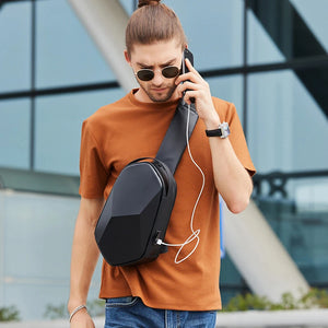 Black crossbody bag worn crossbody with charging cable connected to a phone