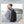 Person wearing expandable waterproof business backpack, black, side view with straps