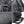 Close-up of black crossbody sling bag showing zippers, label patch, and USB cable pocket
