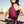 Red waterproof crossbody bag with front pocket and adjustable shoulder strap