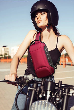 Red waterproof crossbody bag with front pocket and adjustable shoulder strap