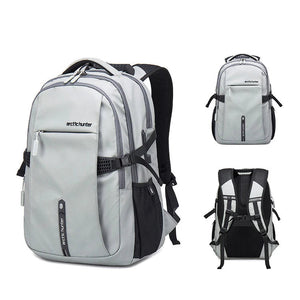 Light gray travel backpack with padded straps and front zip organizer pocket
