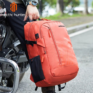 Orange travel backpack carried on shoulder with side straps and front zip pocket