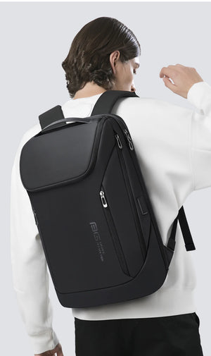 Black backpack worn on back with front zipper pocket and padded shoulder straps