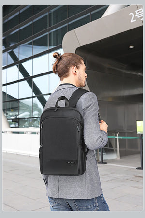 Expandable waterproof business backpack on person, black, front and side with shoulder straps