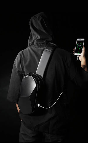 Black crossbody bag with charging cable; phone connected while wearing hoodie