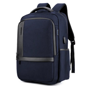 Large capacity waterproof travel backpack with front zip pockets, in navy blue fabric.