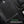 Black backpack with external USB charging port and built-in headphone wire routing.