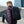 Black backpack from back view with padded straps and front zip pocket