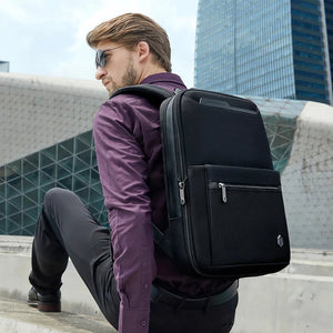 Black backpack from back view with padded straps and front zip pocket