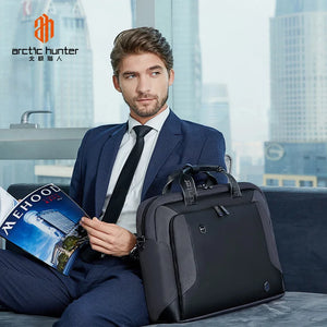 Protective waterproof laptop bag, black with two top handles and detachable shoulder strap
