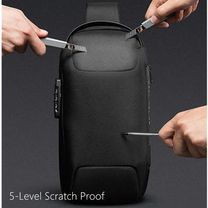 Black crossbody sling bag with top handle and side zip pocket, secured with zipper pulls