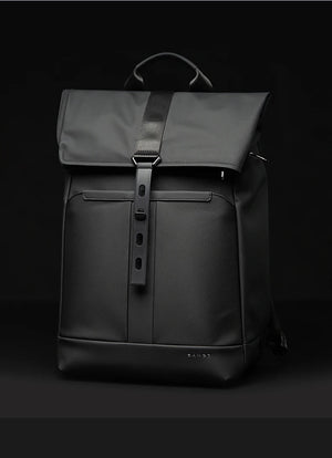 Black travel backpack with top flap, central vertical zipper, and front organizer pocket.