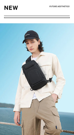 Black compact crossbody bag worn on shoulder with adjustable strap and front zip pocket
