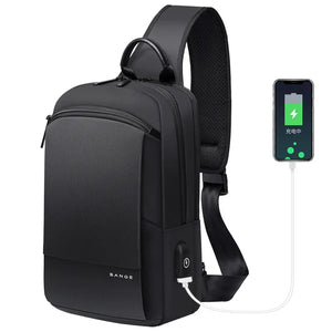 BANGE compact black waterproof crossbody bag with USB charging cable powering a phone