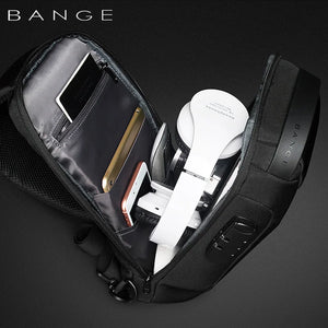 Black crossbody sling bag opened to show interior compartments and zip pockets