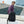 Black backpack with front zip pocket, side carry handle, and top loop