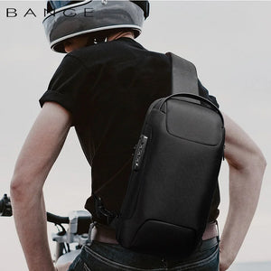 Black waterproof crossbody sling bag worn on back with adjustable strap and front zip