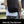 Black waterproof travel backpack with front zip pockets and top grab handle