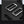 Dark grey roll-top backpack hardware detail with push-button magnetic clasp