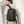 Black waterproof backpack worn on back with front vertical zipper pocket and side strap