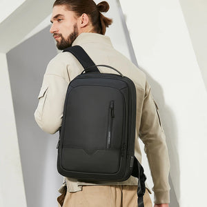 Black waterproof backpack worn on back with front vertical zipper pocket and side strap