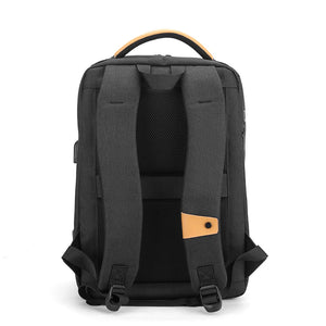 Black waterproof travel backpack with padded front panel and top carry handle.