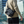 Black compact cross-body bag worn with flap front and strap details