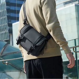 Black compact cross-body bag worn with flap front and strap details