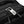 Black zipper track detail with metal pull tab on travel backpack
