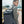 Blue waterproof travel backpack with padded straps and top handle, worn on the back