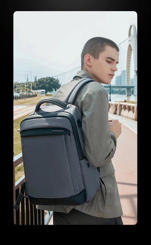 Blue waterproof travel backpack with padded straps and top handle, worn on the back