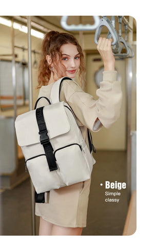Beige compact commuter backpack with front flap, buckle straps, and side straps