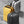 Two compact backpacks: lemon yellow and dark gray with shared black trim details