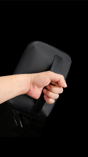 Black waterproof tech storage bag zipper closeup with hand pulling the tab