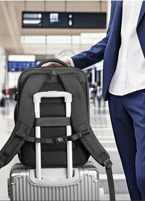Black backpack with trolley sleeve and adjustable straps over a rolling suitcase handle.