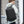 Waterproof travel backpack worn on back, black exterior with side pocket zippers
