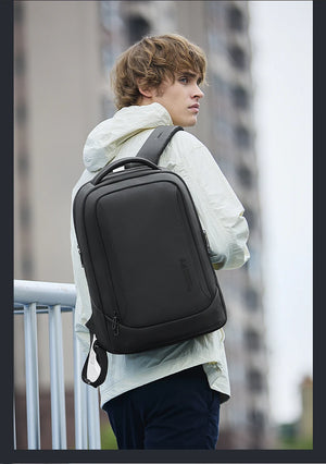 Waterproof travel backpack worn on back, black exterior with side pocket zippers