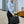 Black laptop bag carried by man with top handle and shoulder strap