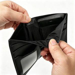 Black leather card holder wallet opening to show card slots and fold pocket.