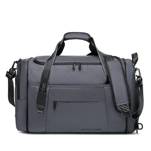 Grey duffle and sports bag with front zipper panel, top handle, and shoulder strap