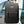 Black commuter backpack with orange accent logo and top handle